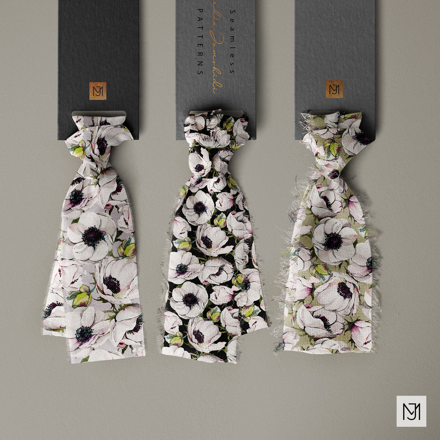 Three fabric swatches of the Anemones pattern hanging from branded tags, in white, black, and olive green colorways of the same anemone print.