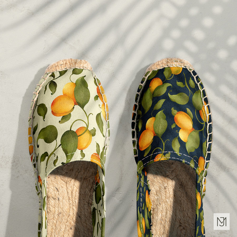 Apricot pattern on a pair of espadrilles, one in a cream colorway and one in navy.