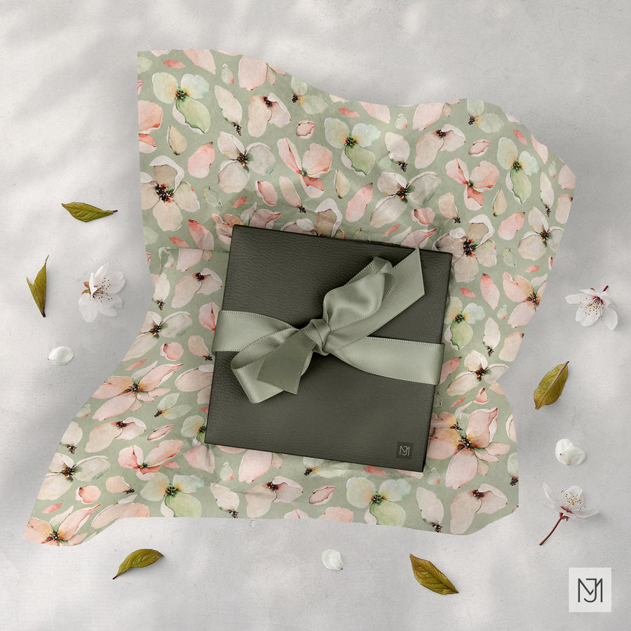 Blossoms pattern printed as sage green wrapping paper around an olive gift box, tied with a matching ribbon bow.