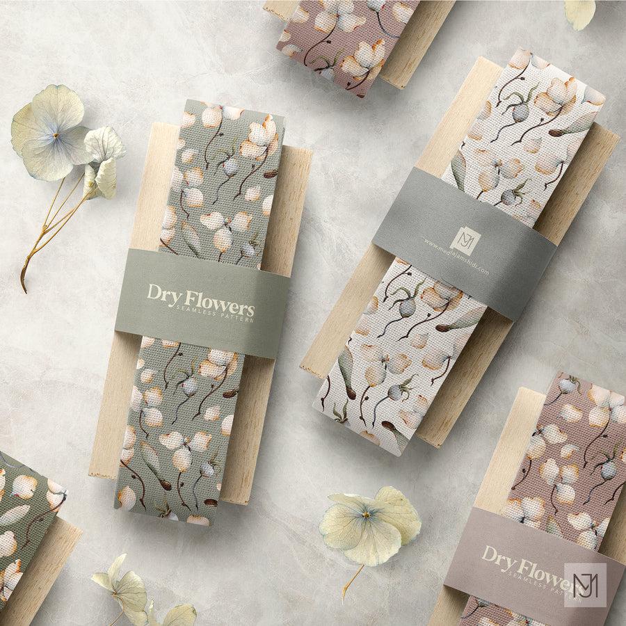 Two fabric strips of the Dry Flowers pattern rolled on wood dowels, one in sage green and one in cream, each with a paper band.