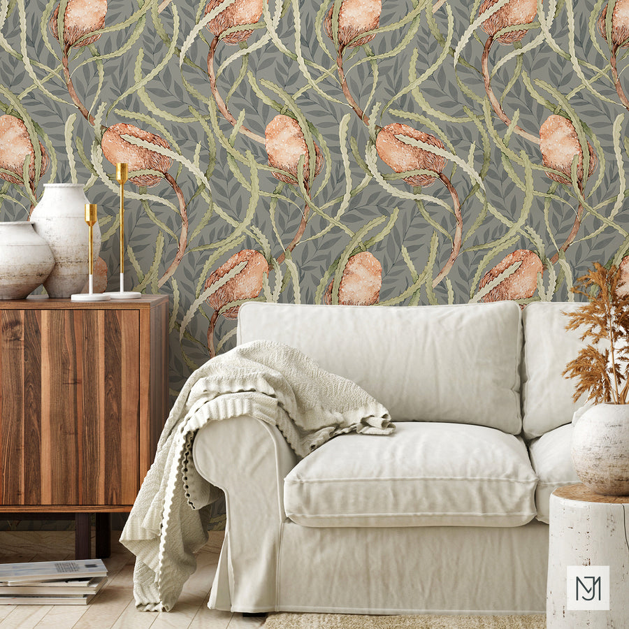 Banksia pattern as wallpaper behind a cream sofa, wood cabinet, and ceramic vases in a living room.
