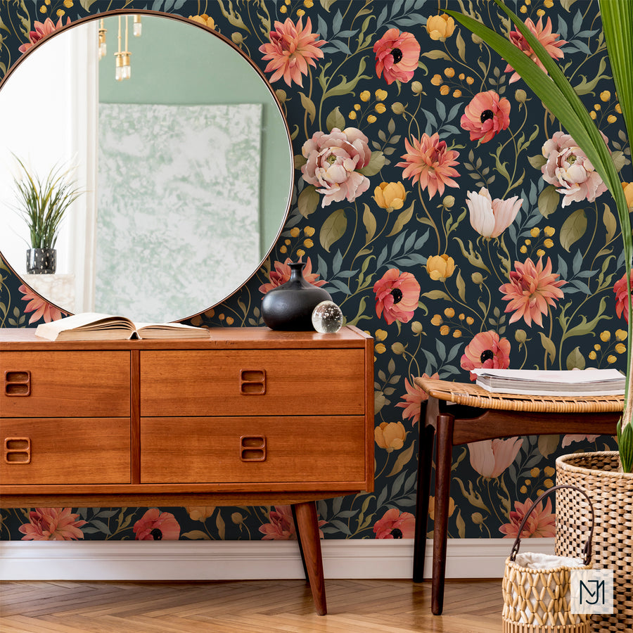 Botanical pattern as wallpaper behind a round mirror, a wood dresser, and a potted plant.
