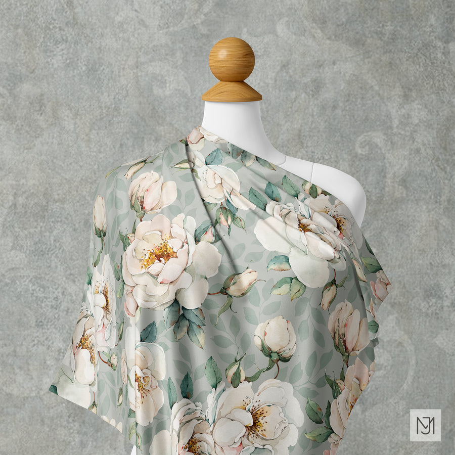 Watercolor Garden Roses pattern draped over a mannequin shoulder in a sage green colorway, with the same cream roses.