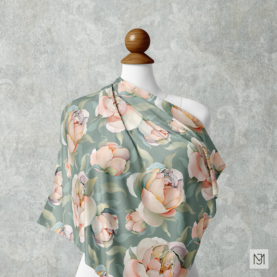 Peonies pattern draped over a mannequin shoulder in a sage green colorway, with the same blush and cream peony blooms.
