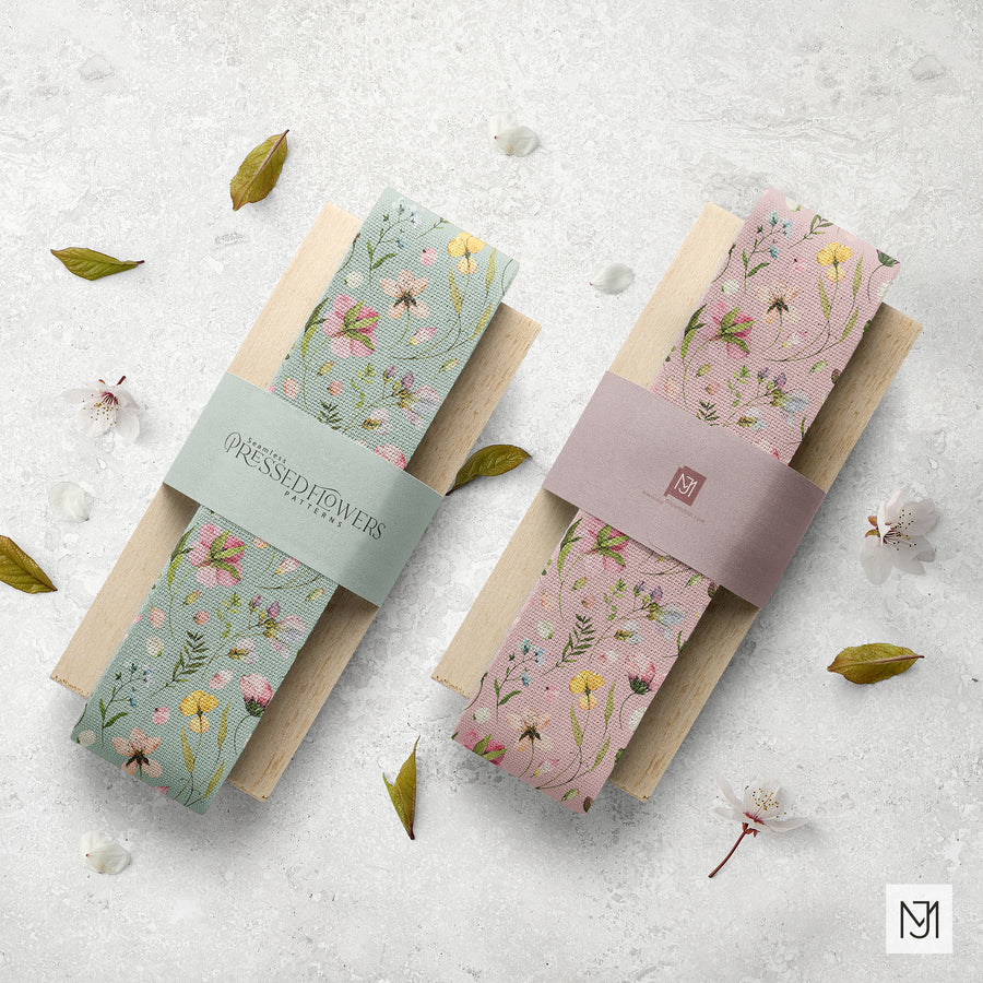 Two knotted fabric ribbons of the Pressed Flowers pattern, one in sage green and one in blush pink, each with a small brand tag.