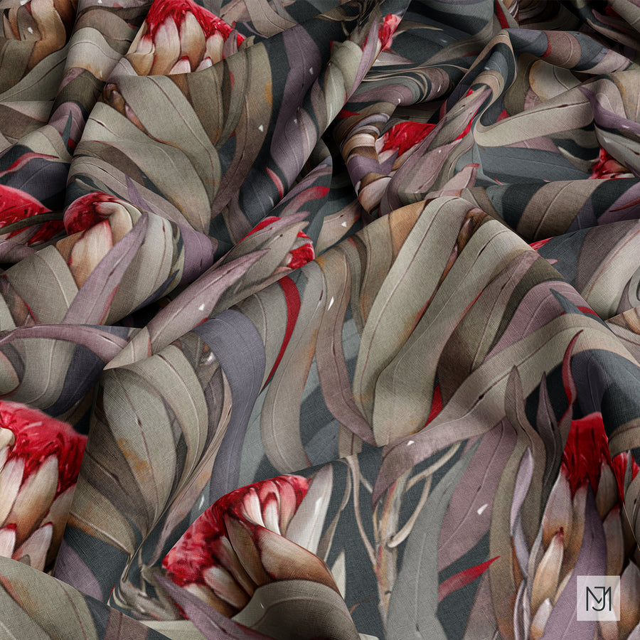 Protea pattern shown on draped and folded fabric, with the same red and cream protea blooms visible across the folds.