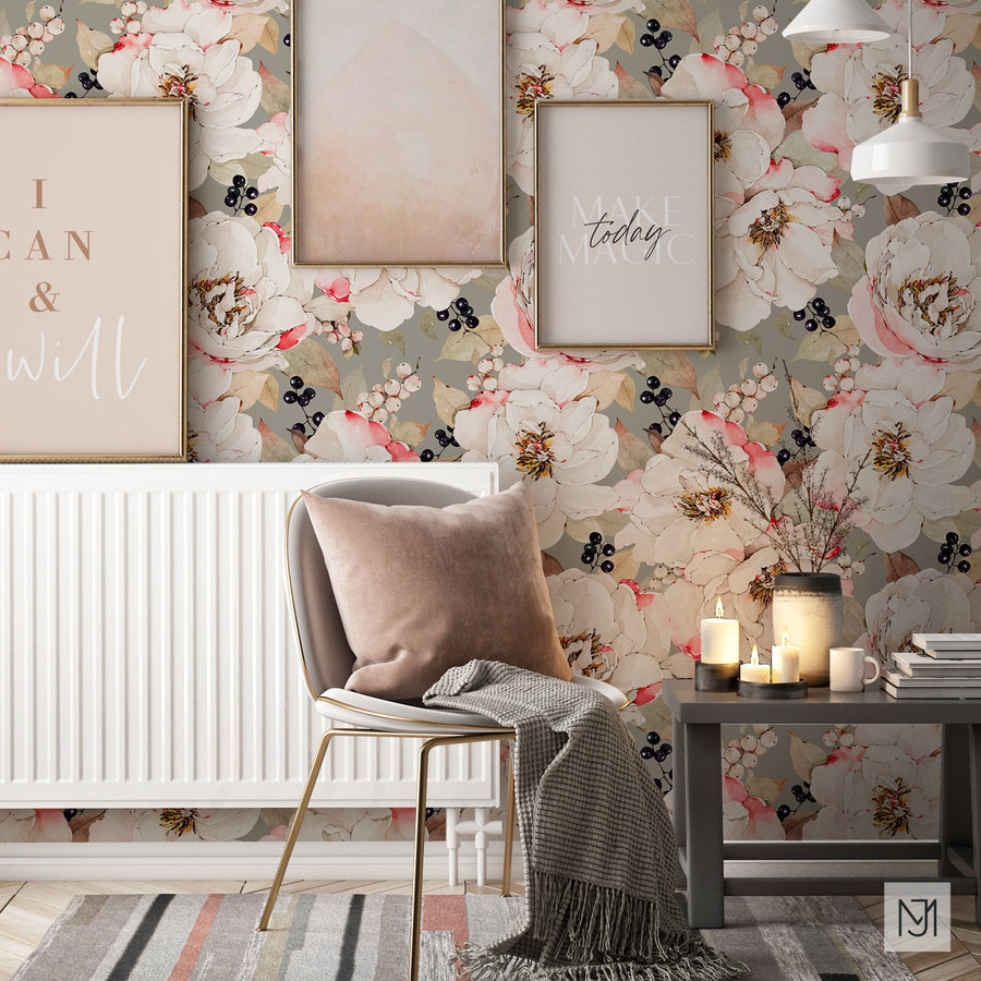 White Peonies pattern as a wallpaper mural behind a gray armchair with a pink pillow, framed art prints, and a side table with lit candles.