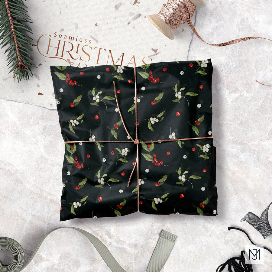 Christmas Winter Berries pattern printed as black wrapping paper with small red and white berries and green leaves, tied with copper ribbon and shown beside a pine sprig.